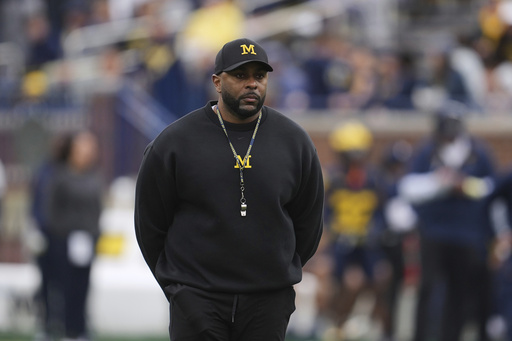 FILE - Michigan head coach Sherrone Moore watches during an NCAA college football spring game in Ann Arbor, Mich., April 19, 2025. (AP Photo/Paul Sancya, file)