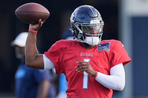 FILE - Tennessee Titans quarterback Cam Ward (1) looks to throw a pass during practice at the team's NFL football training camp Wednesday, July 30, 2025, in Nashville, Tenn. (AP Photo/George Walker IV, File)