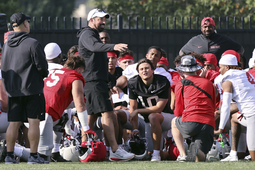 Ohio State coach Ryan Day talks to his team during NCAA college football practice in Columbus, Ohio, Friday, Aug. 1, 2025. (AP Photo/Paul Vernon)
