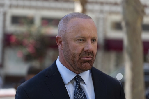 Mathew Bowyer, who pled guilty a year ago to running an illegal gambling business, money laundering and filing a false tax return, talks to his attorney outside federal court, Friday, Aug. 29, 2025, in Santa Ana, Calif., following his sentencing to 12 months and one day in prison, (AP Photo/Jae C. Hong)