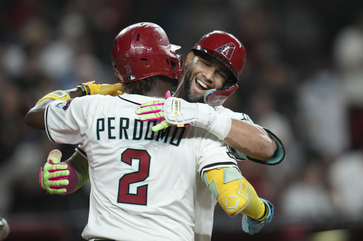 Arizona Diamondbacks' Lourdes Gurriel Jr., right, celebrates his two-run home run against the San Diego Padres with Diamondbacks' Geraldo Perdomo (2) during the eighth inning of a baseball game Tuesday, Aug. 5, 2025, in Phoenix. (AP Photo/Ross D. Franklin)