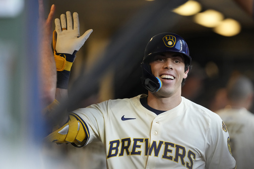Milwaukee Brewers' Christian Yelich smiles in the dugout after hitting a solo home run during the third inning of a baseball game against the Pittsburgh Pirates, Monday, Aug. 11, 2025, in Milwaukee. (AP Photo/Aaron Gash)