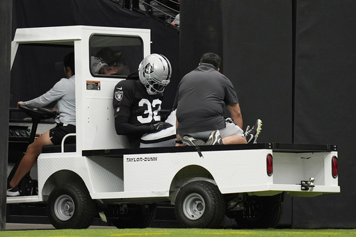 Las Vegas Raiders cornerback Lonnie Johnson Jr. (32) is carted off the field at the team's NFL football training camp Saturday, Aug. 2, 2025, in Las Vegas. (AP Photo/John Locher)