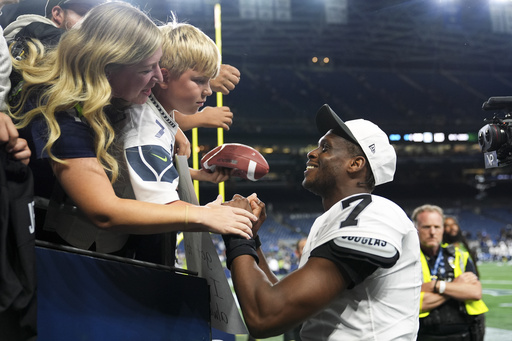Las Vegas Raiders quarterback Geno Smith (7) greets fans after an NFL preseason football game against the Seattle Seahawks, Thursday, Aug. 7, 2025, in Seattle. (AP Photo/Lindsey Wasson)