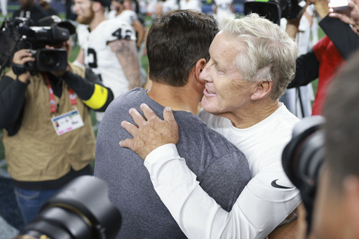 Seattle Seahawks head coach Mike Macdonald, left, hugs Las Vegas Raiders head coach Pete Carroll after an NFL preseason football game Thursday, Aug. 7, 2025, in Seattle. (AP Photo/Maddy Grassy)