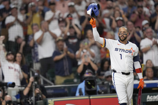Houston Astros' Carlos Correa acknowledges the crowd as he come up to bat against the Boston Red Sox during the first inning of a baseball game Monday, Aug. 11, 2025, in Houston. (AP Photo/David J. Phillip)