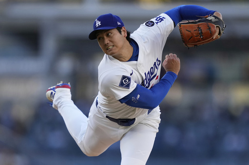 Los Angeles Dodgers starting pitcher Shohei Ohtani works against a Cincinnati Reds batter during the first inning of a baseball game Wednesday, Aug. 27, 2025, in Los Angeles. (AP Photo/Mark J. Terrill)