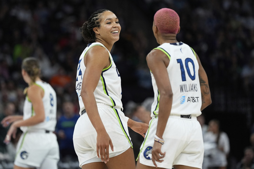 Minnesota Lynx forward Napheesa Collier, center left, and guard Courtney Williams (10) react during the second half of a WNBA basketball game against the Chicago Sky Tuesday, July 22, 2025, in Minneapolis. (AP Photo/Abbie Parr)