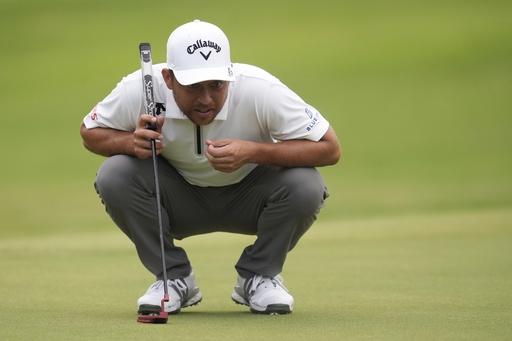 Xander Schauffele eyes a putt on the first green during the second round of the St. Jude Championship golf tournament Friday, Aug. 8, 2025, in Memphis, Tenn. (AP Photo/George Walker IV)