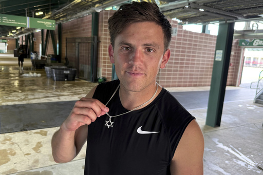 New Tulane quarterback Jake Retzlaff, a transfer from BYU, shows off the Star of David on his necklace after football practice at Yulman Stadium in New Orleans, on Friday, Aug. 1, 2025. (AP Photo/Brett Martel)