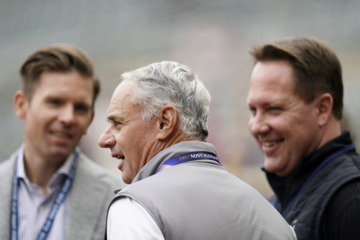 FILE - MLB Commissioner Rob Manfred, center, talks with Minnesota Twins executive vice president Joe Pohlad, left, and Twins president of baseball operations Derek Falvey before Game 2 of an AL wild-card baseball playoff series between the Twins and the Toronto Blue Jays Wednesday, Oct. 4, 2023, in Minneapolis. (AP Photo/Abbie Parr, File)