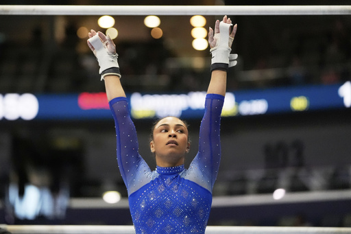 Hezly Rivera of WOGA reacts after competing on the uneven bars during the senior women's finals of the U.S. Gymnastics Championships in New Orleans, Sunday, Aug. 10, 2025. (AP Photo/Gerald Herbert)