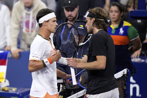 Daniel Altmaier, left, of Germany, is congratulated by Stefanos Tsitsipas, of Greece, after defeating him during the second round of the U.S. Open tennis championships, Thursday, Aug. 28, 2025, in New York. (AP Photo/Frank Franklin II)