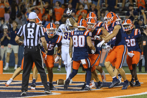 Illinois wide receiver Hank Beatty (80) celebrates a punt return for a touchdown with his team during the second half of an NCAA college football game against Western Illinois Friday, Aug. 29, 2025, in Champaign, Ill. (AP Photo/Craig Pessman)