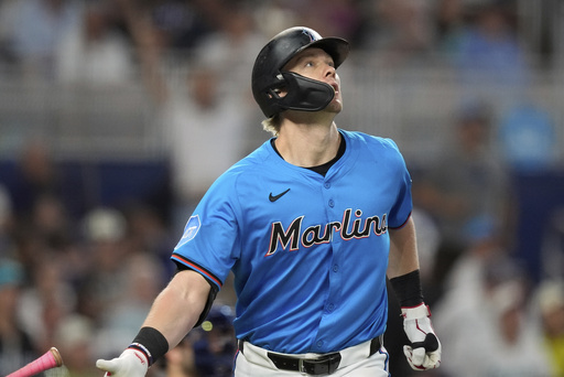 Miami Marlins' Kyle Stowers watches his ball after hitting a three-run homer in the fourth inning of a baseball game against the New York Yankees, Sunday, Aug. 3, 2025, in Miami. (AP Photo/Rebecca Blackwell)