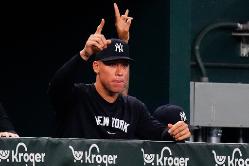 New York Yankees Aaron Judge gestures in the dugout during the second inning of a baseball game against the Texas Rangers, Monday, Aug. 4, 2025, in Arlington, Texas. (AP Photo/LM Otero)
