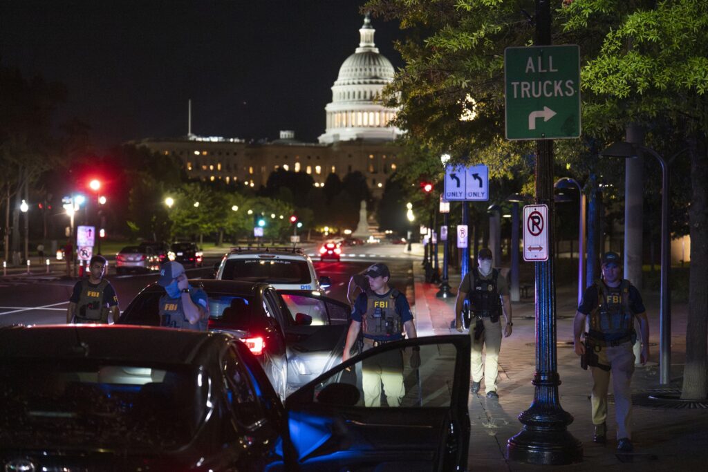 Federal Bureau of Investigation and Metropolitan Police Department officers conduct a traffic stop near the U.S. Capitol on Aug. 14, 2025 in Washington, D.C.  (Photo by Kayla Bartkowski/Getty Images)