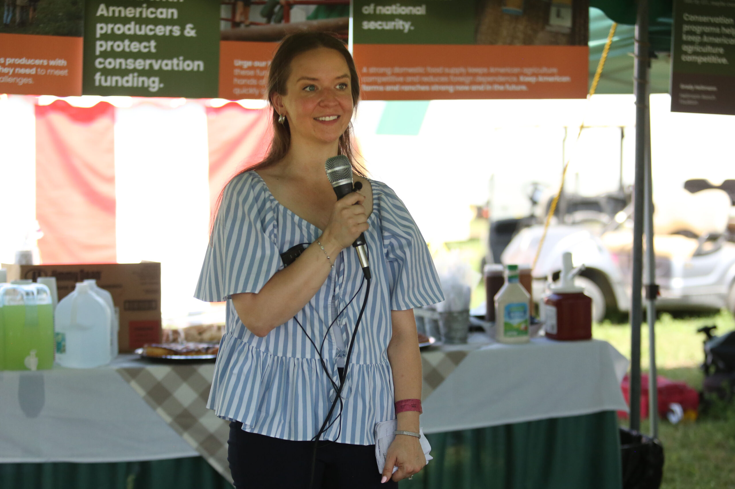 Invest in Our Land Executive Director Rebecca Bartels speaks at Dakotafest in Mitchell on Aug. 20, 2025. (Makenzie Huber/South Dakota Searchlight)