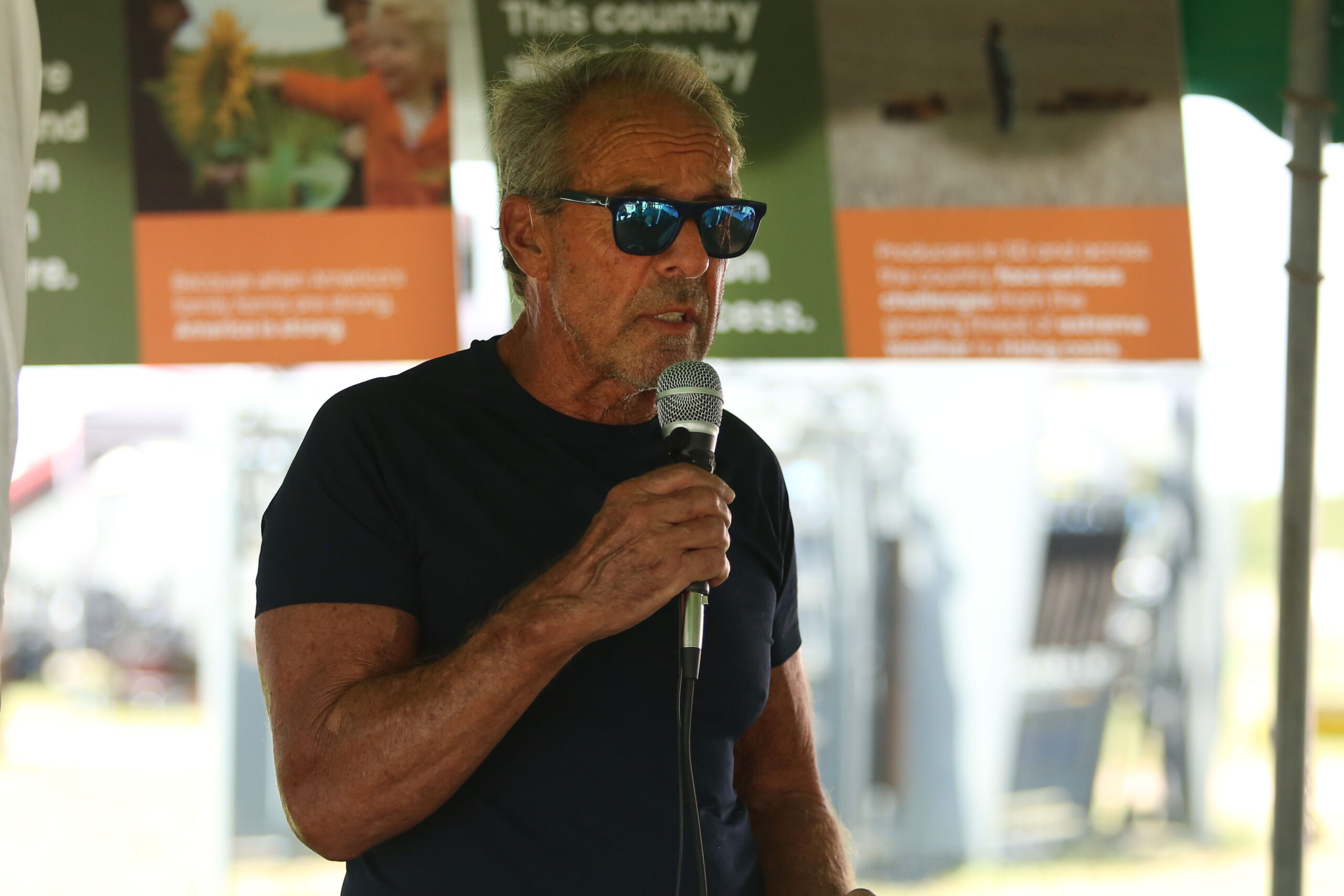 Mitchell farmer Gene Stehly speaks at Dakotafest in Mitchell on Aug. 20, 2025. (Makenzie Huber/South Dakota Searchlight)