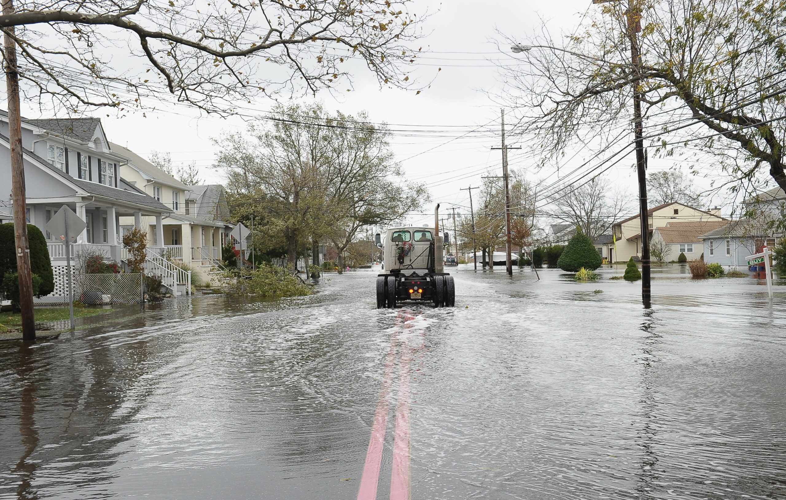A truck cab drives through a neighborhood flooded by Hurricane Sandy on Oct. 30, 2012 in Point Pleasant Beach, New Jersey. (Photo by Michael Loccisano/Getty Images)