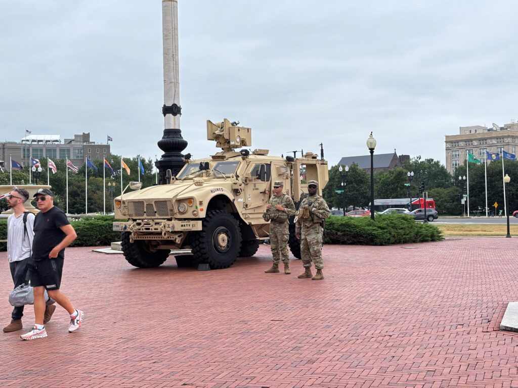 Tourists pass by members of the National Guard stationed outside Union Station in Washington, D.C., on Aug. 18, 2025. (Photo by Jane Norman/States Newsroom)