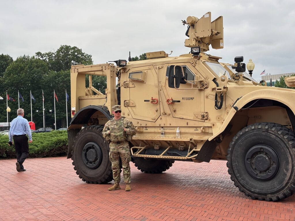 A member of the National Guard stands alongside a military vehicle parked in front of Union Station, near the U.S. Capitol in Washington, D.C., on Aug. 18, 2025. (Photo by Jane Norman/States Newsroom)