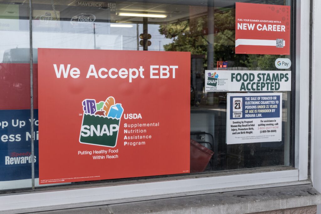 A sign in an Indianapolis store shown on Aug. 1, 2023, says SNAP benefits are accepted. A new analysis by the Congressional Budget Office projects 2.4 million fewer people per month will participate in the program under Republicans’ tax cut and spending law. (Photo by Getty Images)