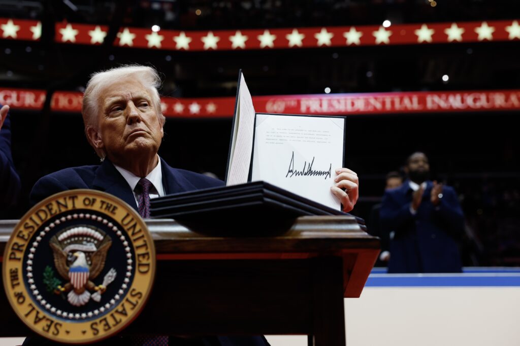 President Donald Trump holds up an executive order after signing it during an indoor inauguration parade at the Capital One Arena on Jan. 20, 2025 in Washington, D.C.  (Photo by Anna Moneymaker/Getty Images)