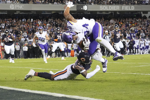 Minnesota Vikings tight end Josh Oliver, right, is stopped short of the end zone by Chicago Bears defensive back Jonathan Owens during the second half of an NFL football game Monday, Sept. 8, 2025, in Chicago. (AP Photo/Nam Y. Huh)
