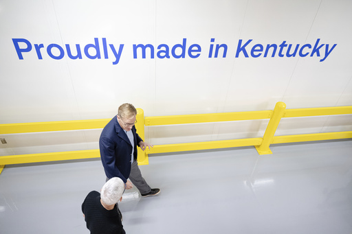Apple CEO Tim Cook and Corning CEO Wendell Weeks walk during a tour of Corning's iPhone glass manufacturing facility Friday, Sept. 12, 2025, in Harrodsburg, Ky. (AP Photo/Jon Cherry)