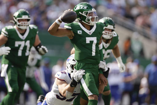 New York Jets quarterback Justin Fields (7) is sacked by Buffalo Bills defensive end Joey Bosa (97) during the fourth quarter of an NFL football game, Sunday, Sept. 14, 2025, in East Rutherford, N.J. (AP Photo/Adam Hunger)