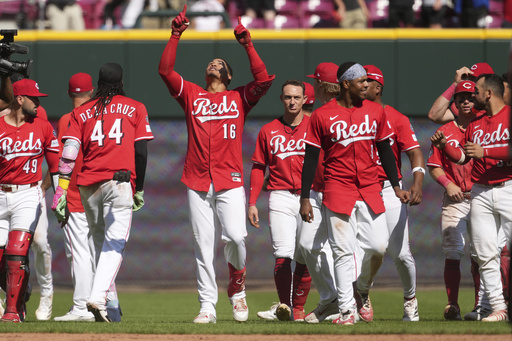 Cincinnati Reds' Noelvi Marte (16) celebrates with teammates after hitting a walkoff two-run single in the ninth inning of a baseball game against the Toronto Blue Jays, Monday, Sept. 1, 2025, in Cincinnati. (AP Photo/Kareem Elgazzar)
