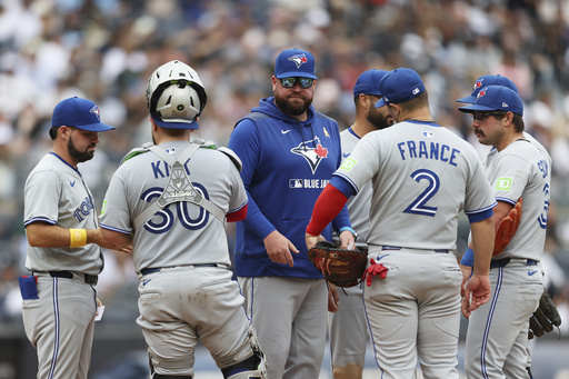 Toronto Blue Jays manager John Schneider, center, stands on the mound after pulling Max Scherzer during the fifth inning of a baseball game against the New York Yankees, Sunday, Sept. 7, 2025, in New York. (AP Photo/Heather Khalifa)