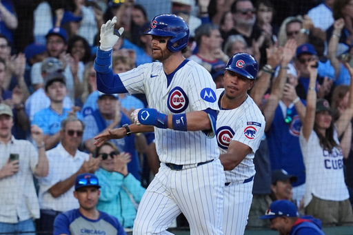 Chicago Cubs' Carson Kelly, left, is congratulated by third base coach Quintin Berry, right, after hitting a two-run home run during the eighth inning of a baseball game against the Atlanta Braves in Chicago, Monday, Sept. 1, 2025. (AP Photo/Nam Y. Huh)
