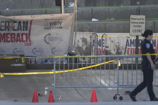A police officer walks near the scene of the shooting of Charlie Kirk at Utah Valley University in Orem, Utah, Thursday, Sept. 11, 2025. (AP Photo/Lindsey Wasson)