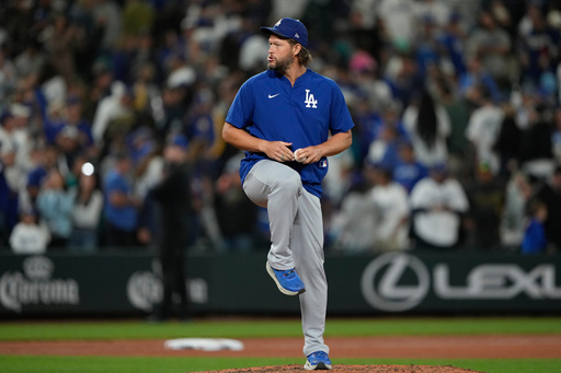 Los Angeles Dodgers starting pitcher Clayton Kershaw pretends to throw on the mound after the team's win in a baseball game against the Seattle Mariners, Friday, Sept. 26, 2025, in Seattle. (AP Photo/Ryan Sun)