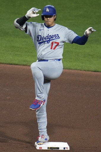 Los Angeles Dodgers' Shohei Ohtani celebrates as he stands on second base after hitting a double off Pittsburgh Pirates pitcher Mike Burrows during the fifth inning of a baseball game in Pittsburgh, Wednesday, Sept. 3, 2025. (AP Photo/Gene J. Puskar)