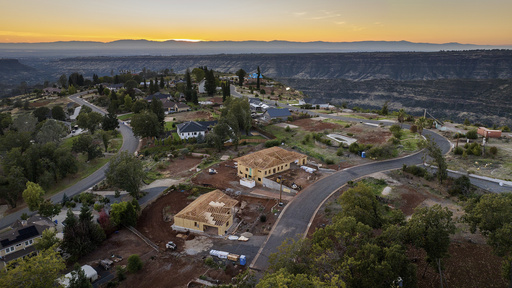 FILE - The sun sets over Valley Ridge Drive, Oct. 26, 2023, in Paradise, Calif. (AP Photo/Noah Berger, File)