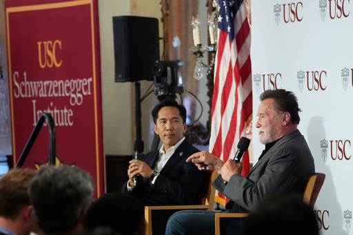 Former California Gov. Arnold Schwarzenegger, right, joins University of Southern California interim president Beong-Soo Kim for a conversation on democracy and Schwarzenegger's opposition to Proposition 50, a California ballot measure to redraw U.S. House maps to boost Democrats, at the USC campus in Los Angeles, Monday, Sept. 15, 2025. (AP Photo/Damian Dovarganes)