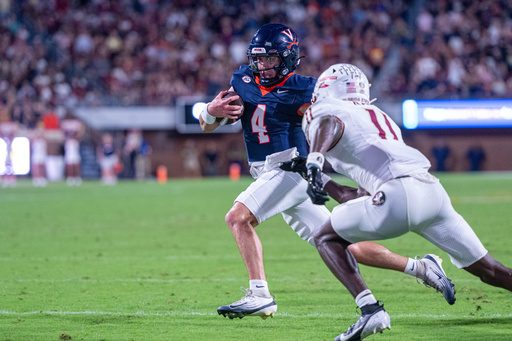 Virginia quarterback Chandler Morris (4) runs the ball in for a touchdown during the first half of an NCAA college football game, Friday, Sept. 26 2025, in Charlottesville, Va. (AP Photo/Robert Simmons)