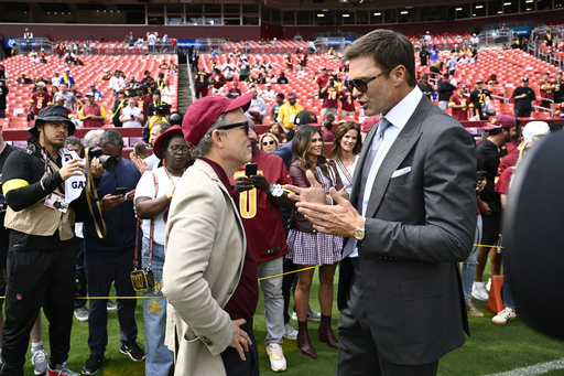 Washington Commanders owenr Josh Harris, right, talks with former NFL quarterback Tom Brady, right, before the start of an NFL football game against the New York Giants, Sunday, Sept. 7, 2025, in Landover, Md. (AP Photo/Nick Wass)