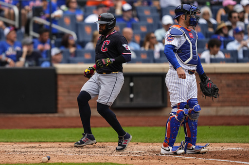 Cleveland Guardians' Carlos Santana (41) scores during the sixth inning of a baseball game against the New York Mets, Wednesday, Aug. 6, 2025, in New York. (AP Photo/Yuki Iwamura)