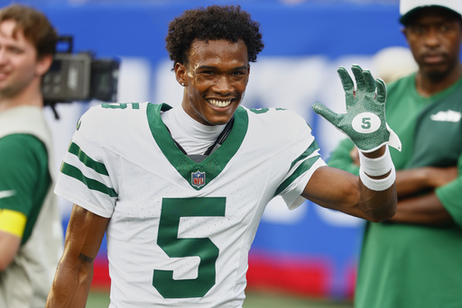 FILE - New York Jets wide receiver Garrett Wilson (5) smiles before playing against the New York Giants in a preseason NFL football game, Saturday, Aug. 16, 2025, in East Rutherford, N.J. (AP Photo/Noah K. Murray, File)