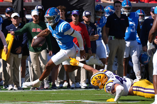 Mississippi quarterback Trinidad Chambliss (6) evades a tackle attempt by LSU linebacker Whit Weeks (40) during the first half of an NCAA college football game in Oxford, Miss., Saturday, Sept. 27, 2025. (AP Photo/Rogelio V. Solis)