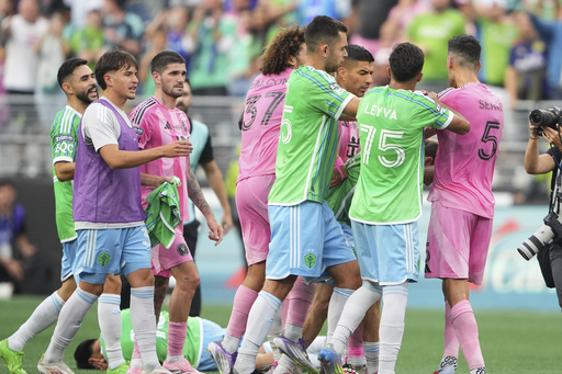 Seattle Sounders midfielder Obed Vargas, bottom left, lies on the ground after being pushed during an altercation against Inter Miami, including forward Luis Suárez and midfielder Sergio Busquets (5) after the Sounders won a Leagues Cup final soccer match Sunday, Aug. 31, 2025, in Seattle. (AP Photo/Lindsey Wasson)