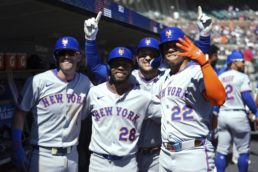 New York Mets' Juan Soto (22) celebrates his grand slam with Jeff McNeil (1), Cedric Mullins (28) and Luis Torrens (13) against the Detroit Tigers in the fourth inning during a baseball game Monday, Sept. 1, 2025, in Detroit. (AP Photo/Paul Sancya)