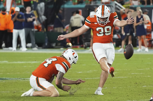 Miami kicker Carter Davis (39) kicks the game winning field goal during the second half of an NCAA college football game against Notre Dame, Sunday, Aug. 31, 2025, in Miami Gardens, Fla. (AP Photo/Lynne Sladky)