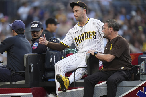 San Diego Padres relief pitcher Jason Adam leaves in a cart after falling with an injury during the seventh inning of a baseball game against the Baltimore Orioles Monday, Sept. 1, 2025, in San Diego. (AP Photo/Gregory Bull)