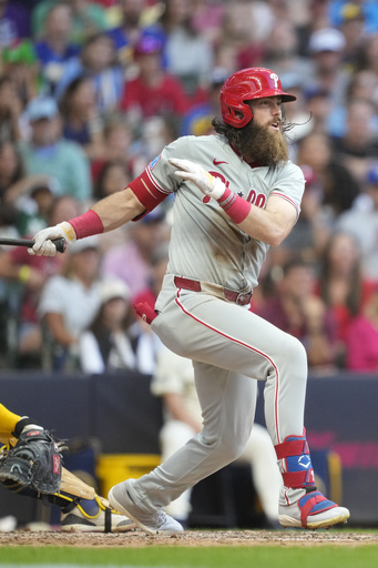 Philadelphia Phillies' Brandon Marsh hits an RBI single allowing Garrett Stubbs to score during the ninth inning of a baseball game against the Milwaukee Brewers, Monday, Sept. 1, 2025, in Milwaukee. (AP Photo/Kayla Wolf)