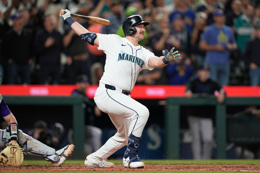 Seattle Mariners' Cal Raleigh watches his 60th home run during the eighth inning of a baseball game against the Colorado Rockies, Wednesday, Sept. 24, 2025, in Seattle. (AP Photo/Ryan Sun)